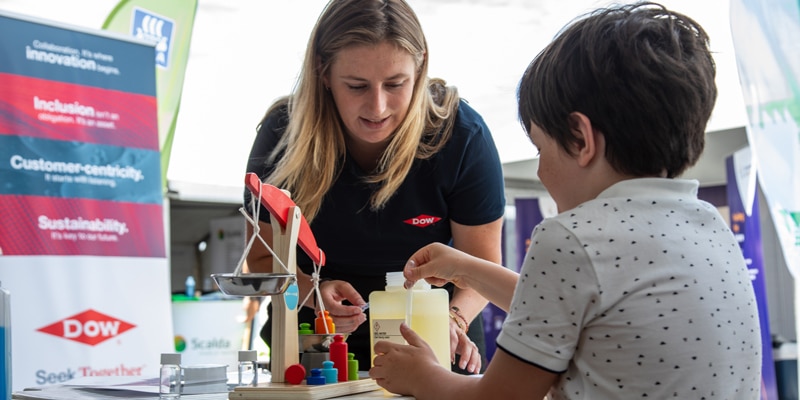 stem event woman and boy at table